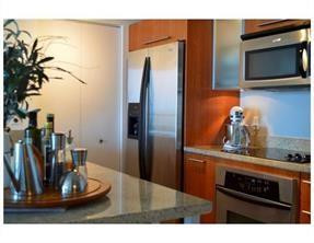 185 Southwest 7th Street, Unit 3507 Miami, FL 33130 - Photo 5 of 19 a kitchen with a refrigerator and a stove