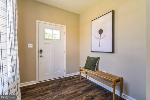 a wooden bench sitting in front of a bathroom