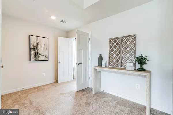 an empty room with windows and cabinet