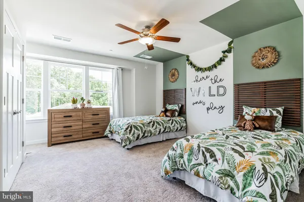 a bedroom with bed and window