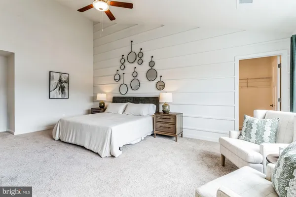a bedroom with furniture and white walls