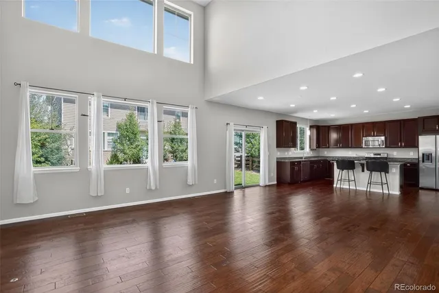 a view of a kitchen with furniture and wooden floor
