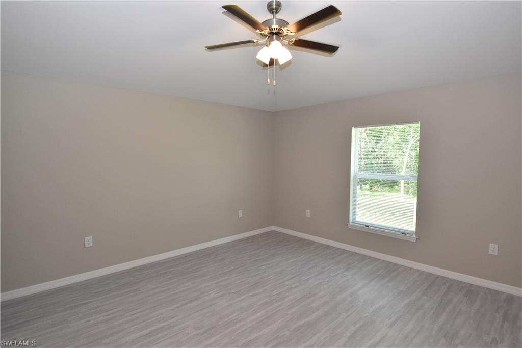 2121 Firebrand Road North Port, FL 34288 - Photo 14 of 22 Empty room with wood finished floors and a ceiling fan