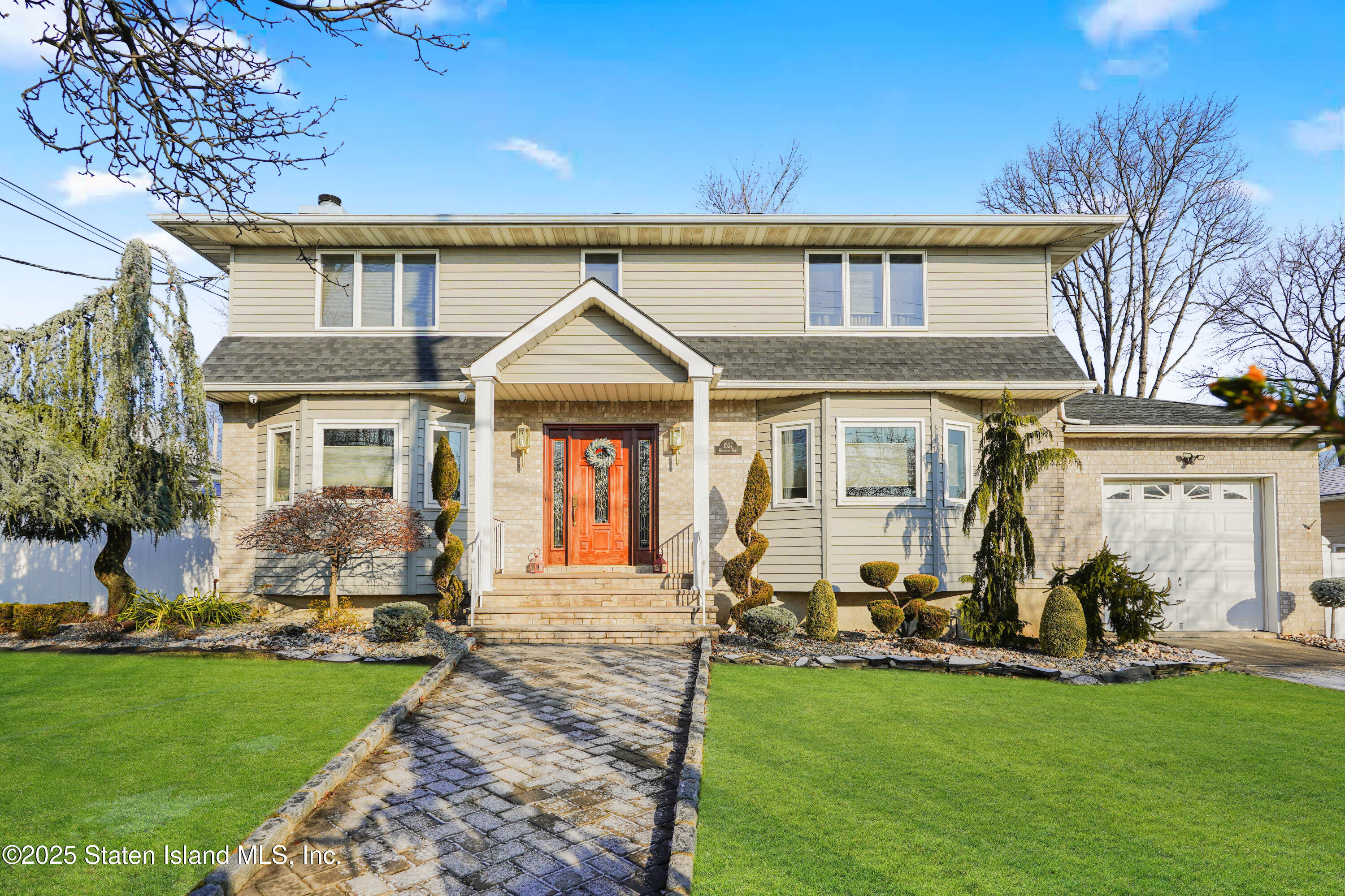 1527 Woodrow Road Staten Island, NY 10309 - Photo 1 of 37 a front view of a house with a yard