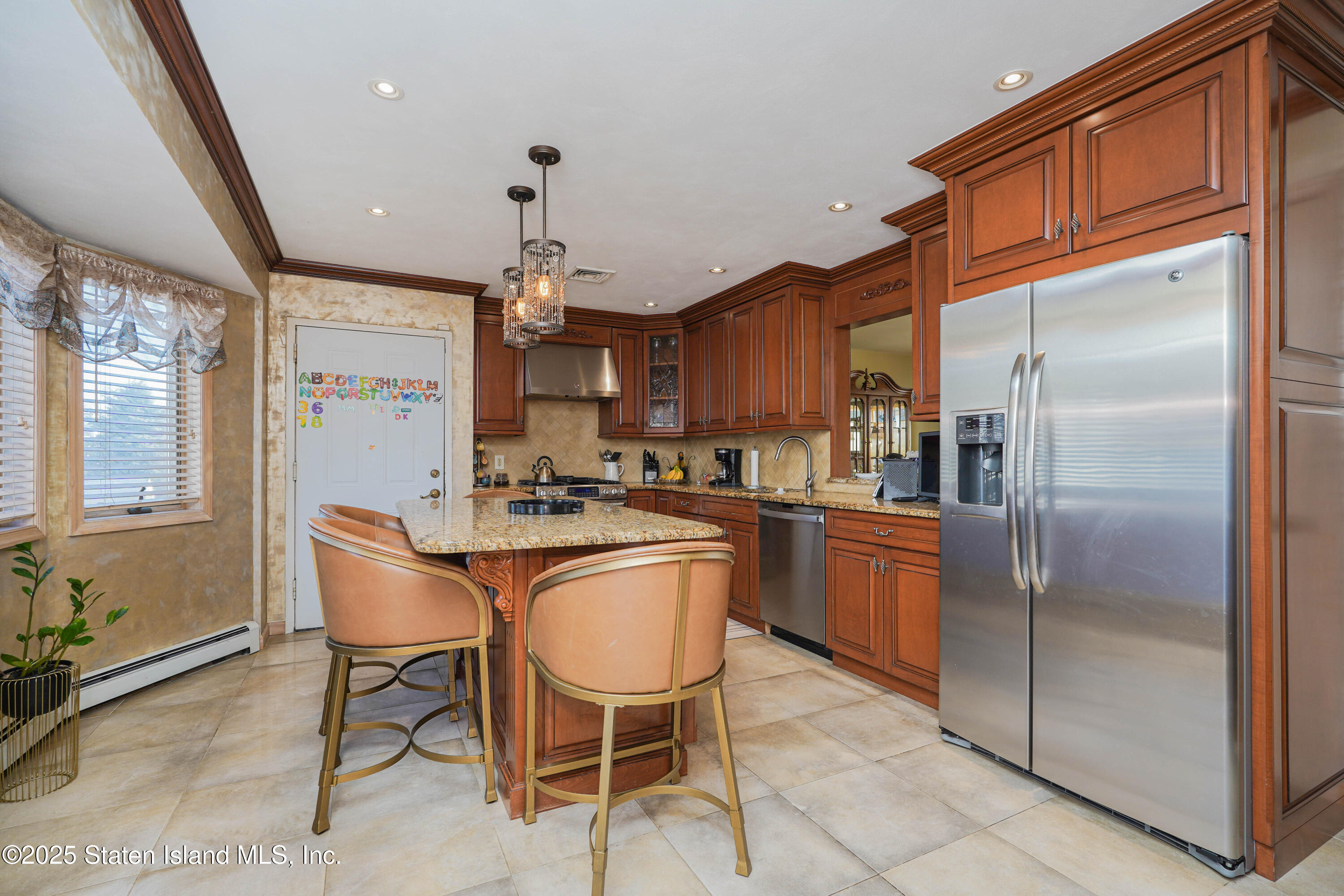 1527 Woodrow Road Staten Island, NY 10309 - Photo 11 of 37 a kitchen with stainless steel appliances granite countertop a refrigerator a sink a stove and island