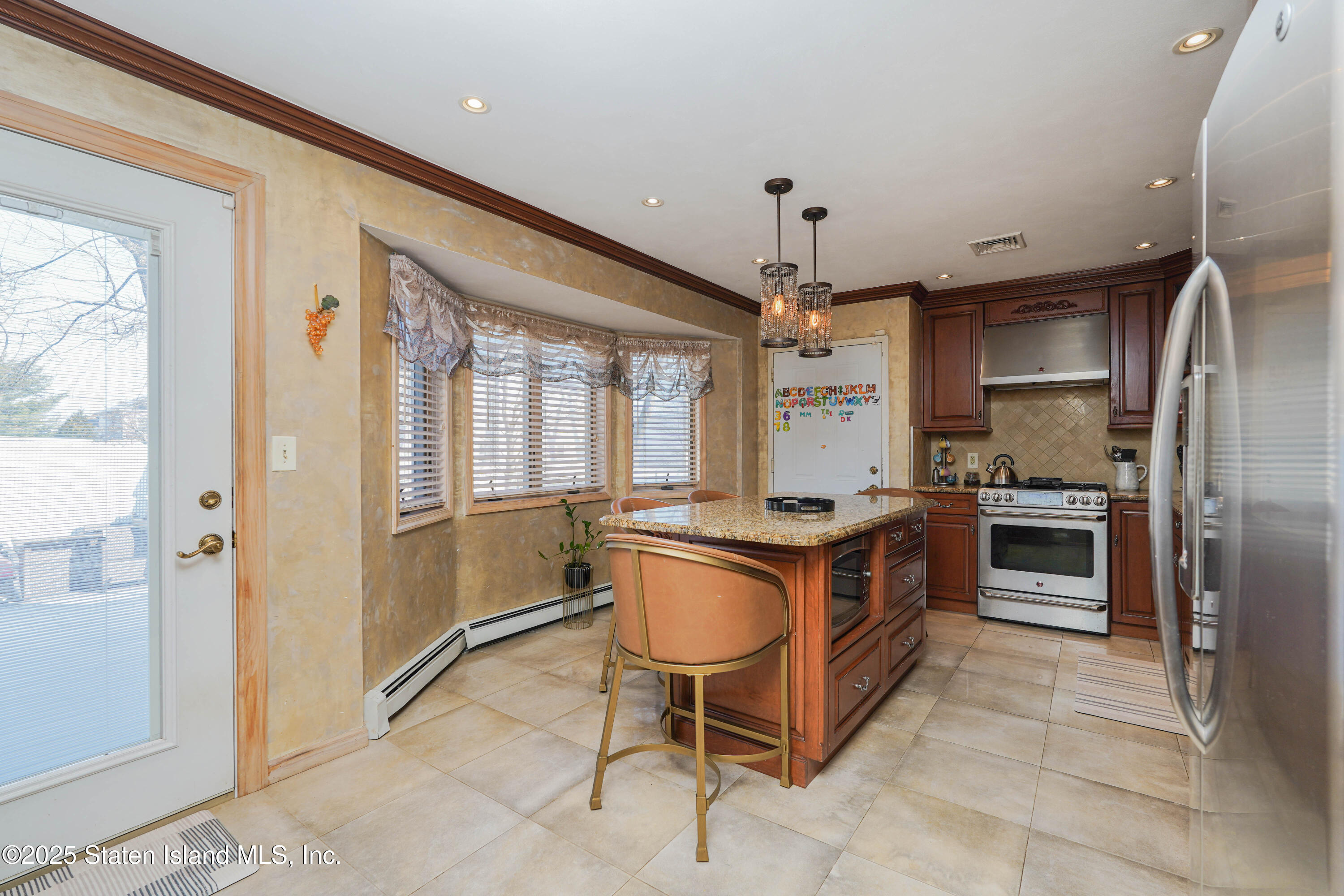 1527 Woodrow Road Staten Island, NY 10309 - Photo 12 of 37 a large kitchen with stainless steel appliances granite countertop a stove and a refrigerator