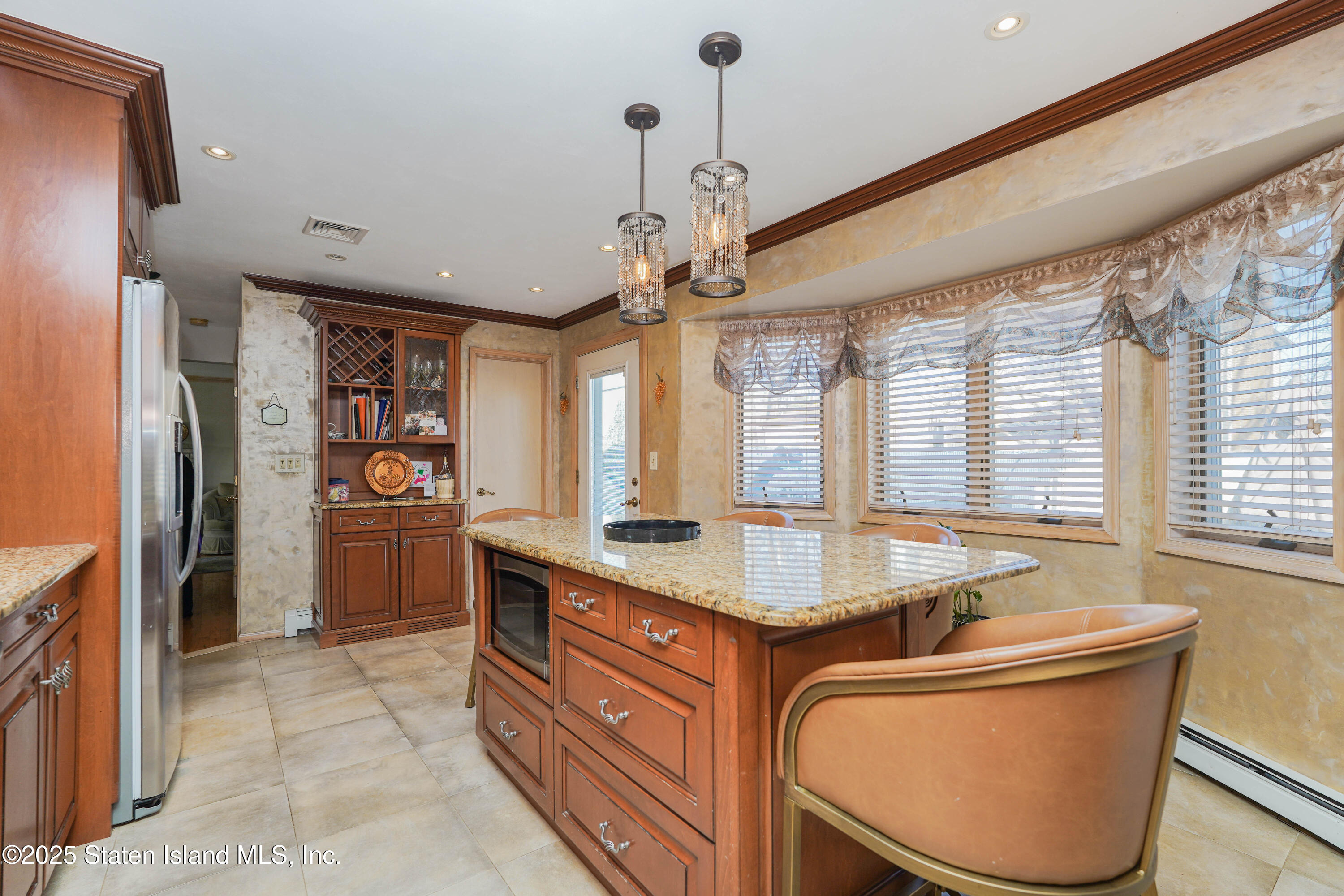 1527 Woodrow Road Staten Island, NY 10309 - Photo 13 of 37 a kitchen with stainless steel appliances granite countertop a sink refrigerator and window