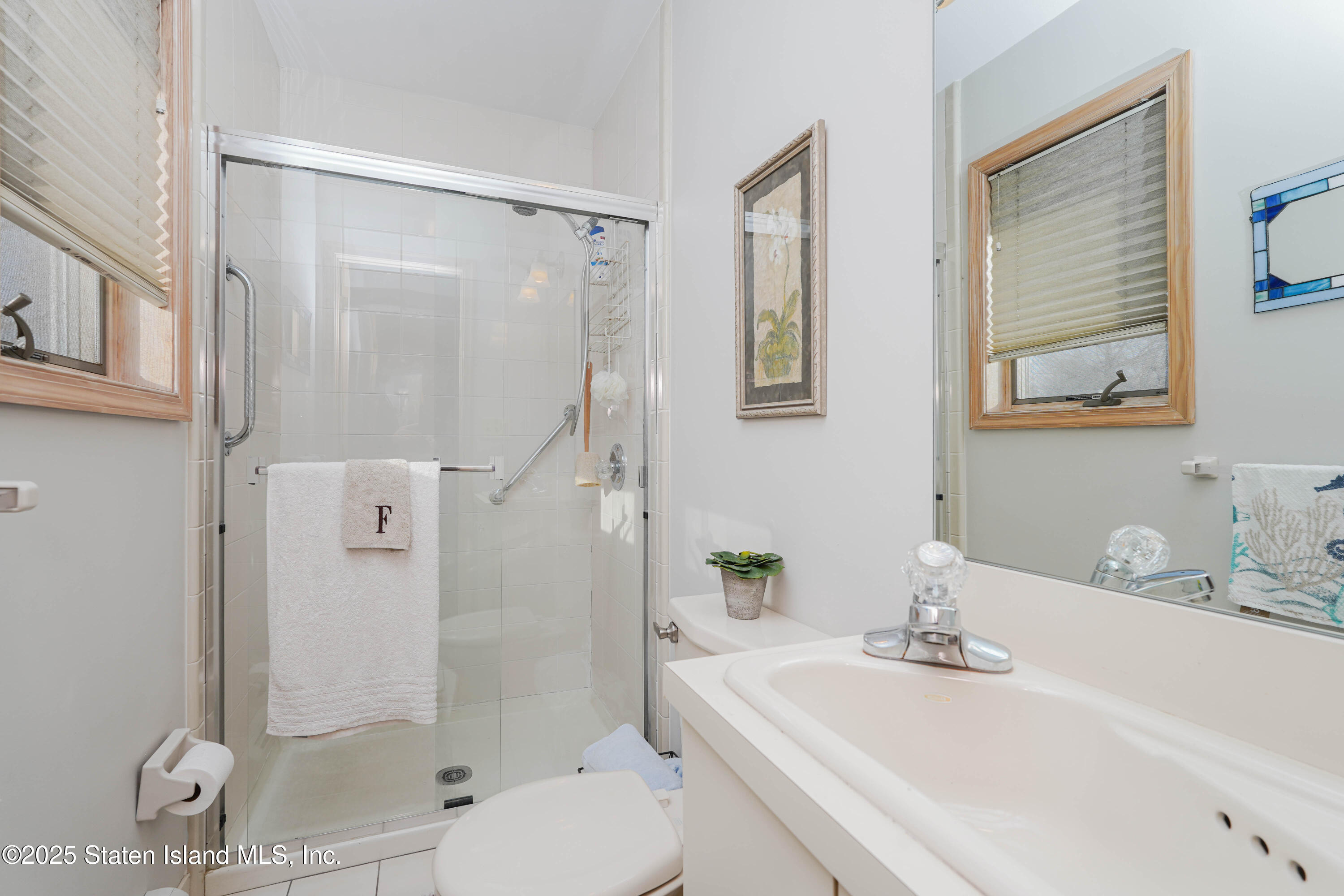 1527 Woodrow Road Staten Island, NY 10309 - Photo 17 of 37 a bathroom with a sink a toilet and shower