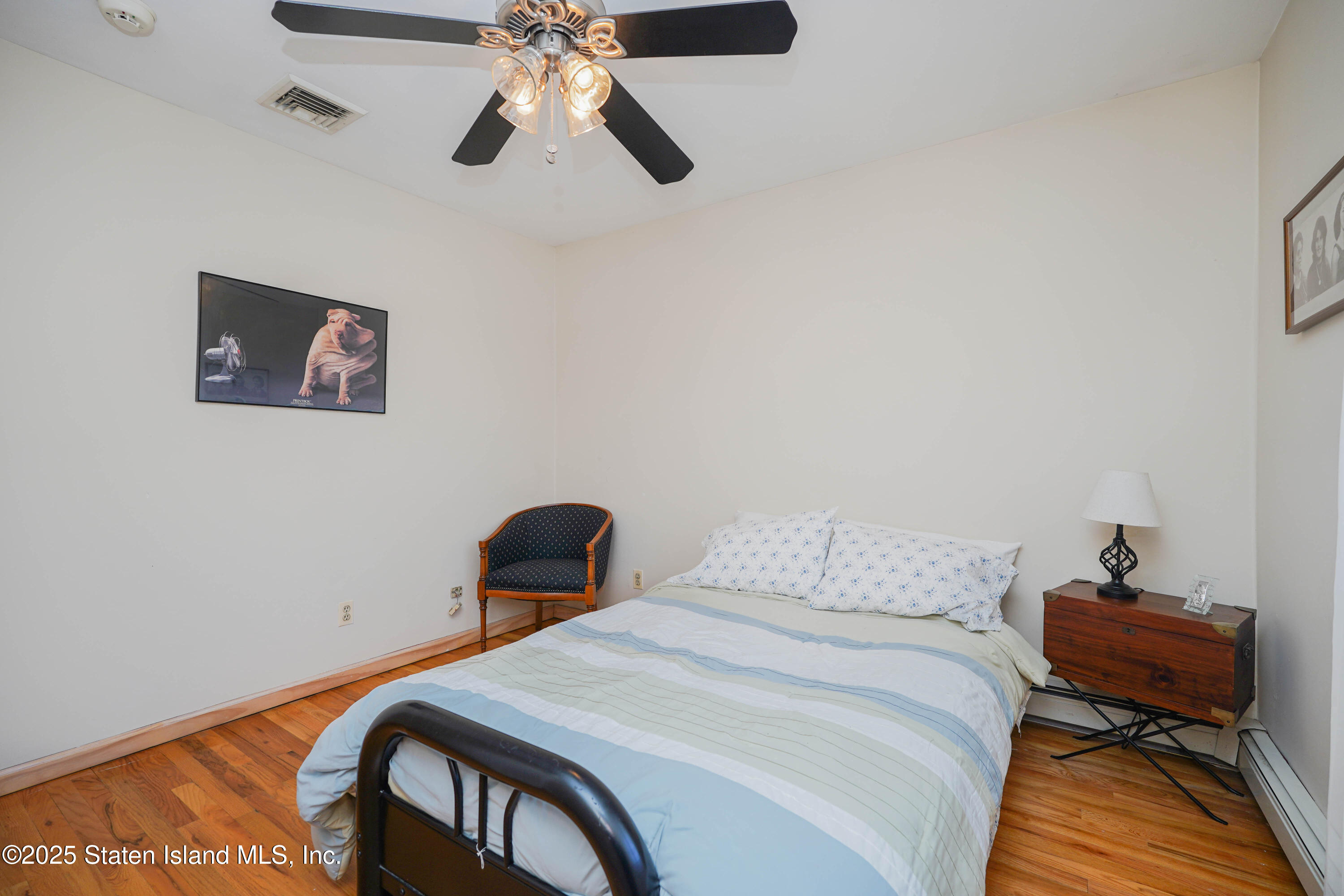 1527 Woodrow Road Staten Island, NY 10309 - Photo 21 of 37 a bedroom with a bed and a chair