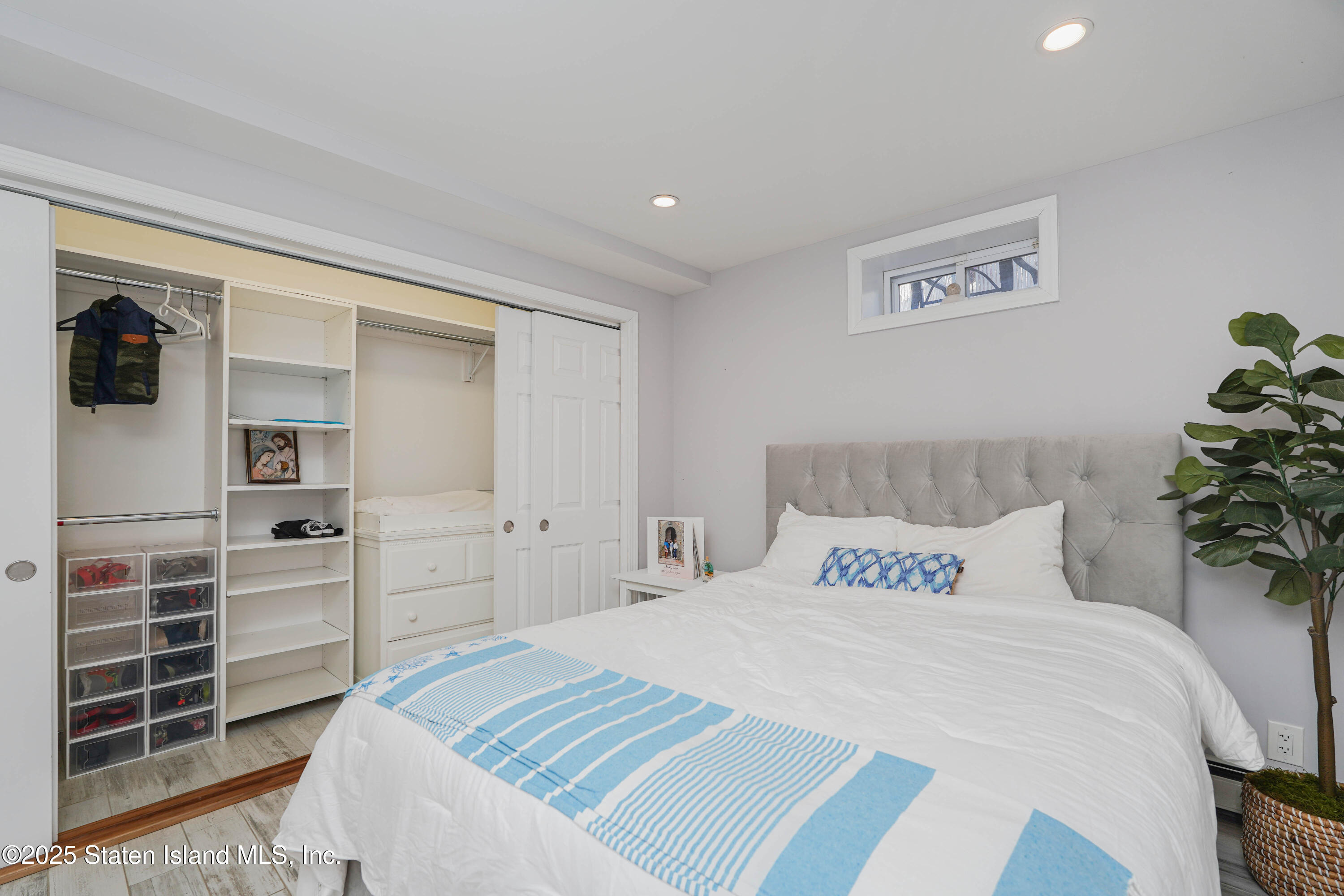 1527 Woodrow Road Staten Island, NY 10309 - Photo 23 of 37 a bedroom with a bed and a window