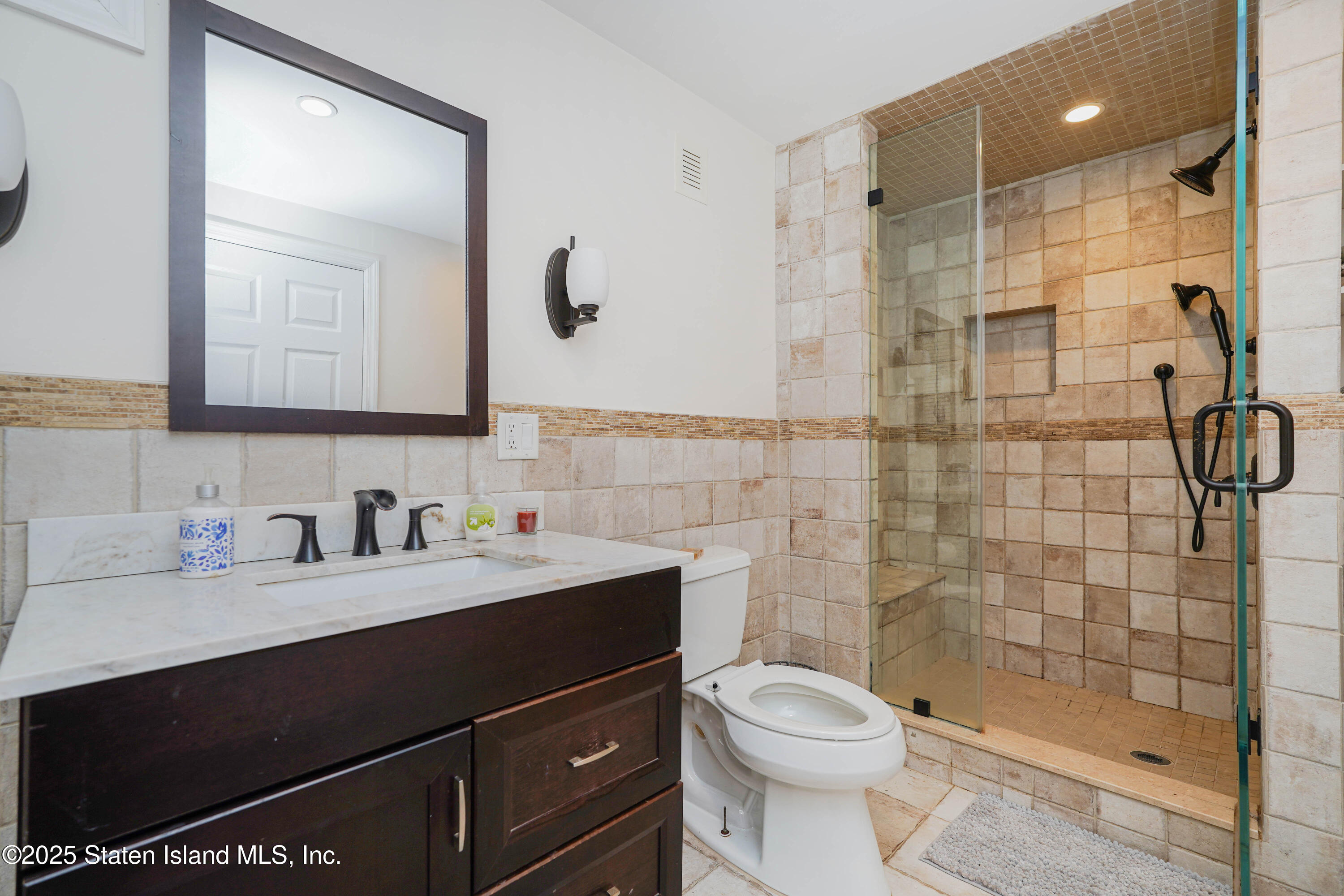 1527 Woodrow Road Staten Island, NY 10309 - Photo 27 of 37 a bathroom with a sink a toilet and shower