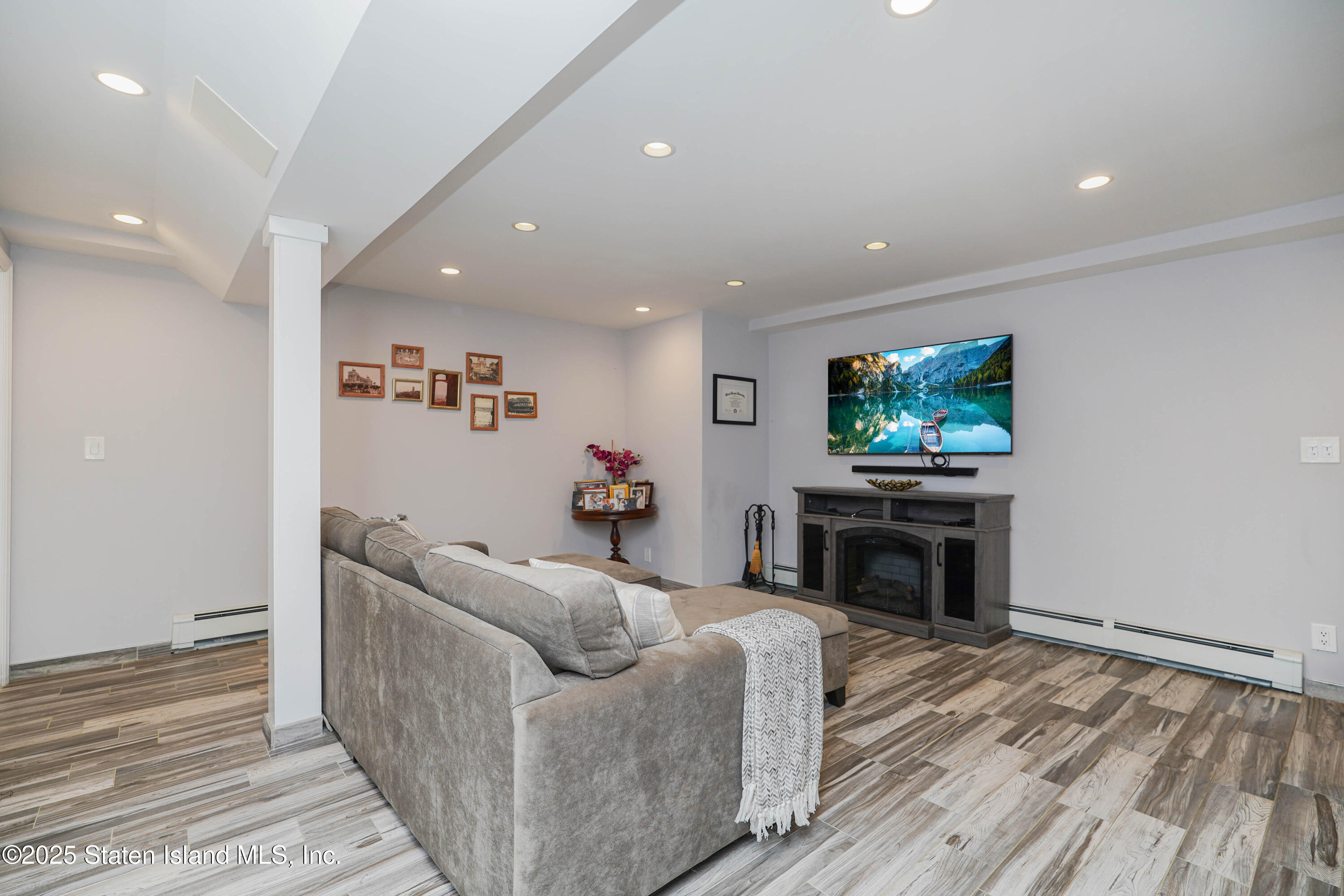 1527 Woodrow Road Staten Island, NY 10309 - Photo 28 of 37 a living room with furniture and a flat screen tv