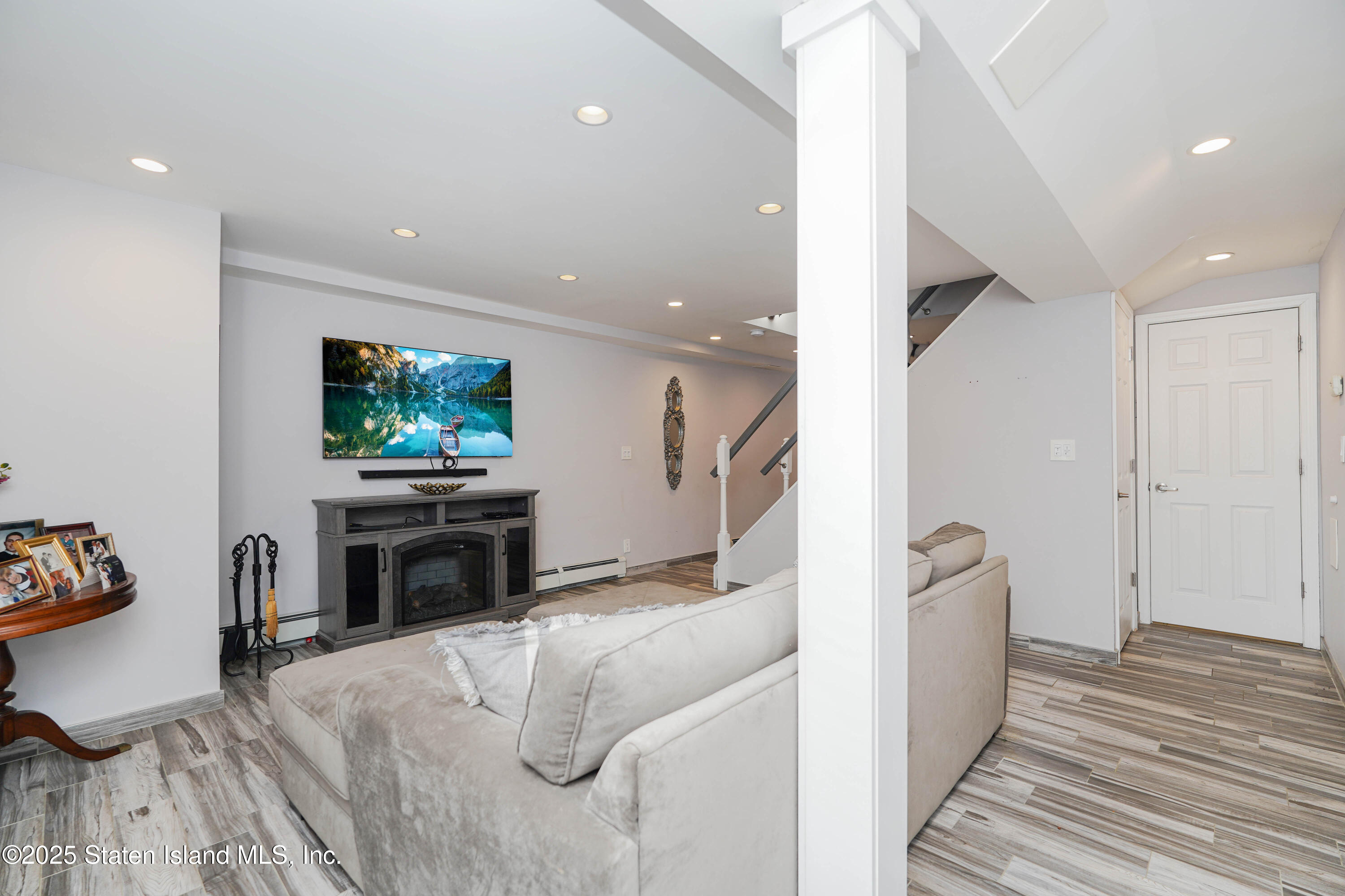 1527 Woodrow Road Staten Island, NY 10309 - Photo 29 of 37 a living room with furniture and a flat screen tv