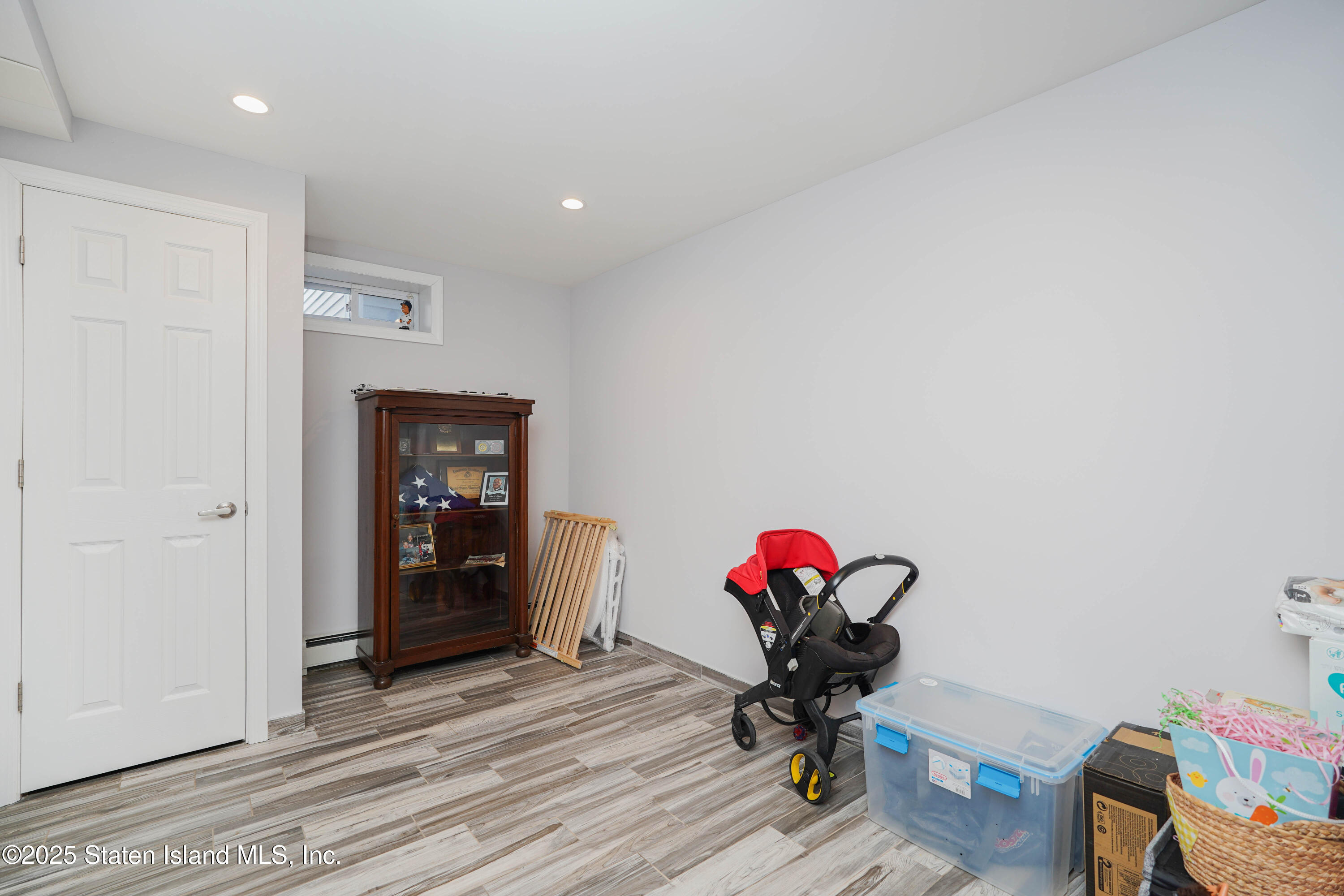 1527 Woodrow Road Staten Island, NY 10309 - Photo 32 of 37 a view of a workspace with furniture and a potted plant