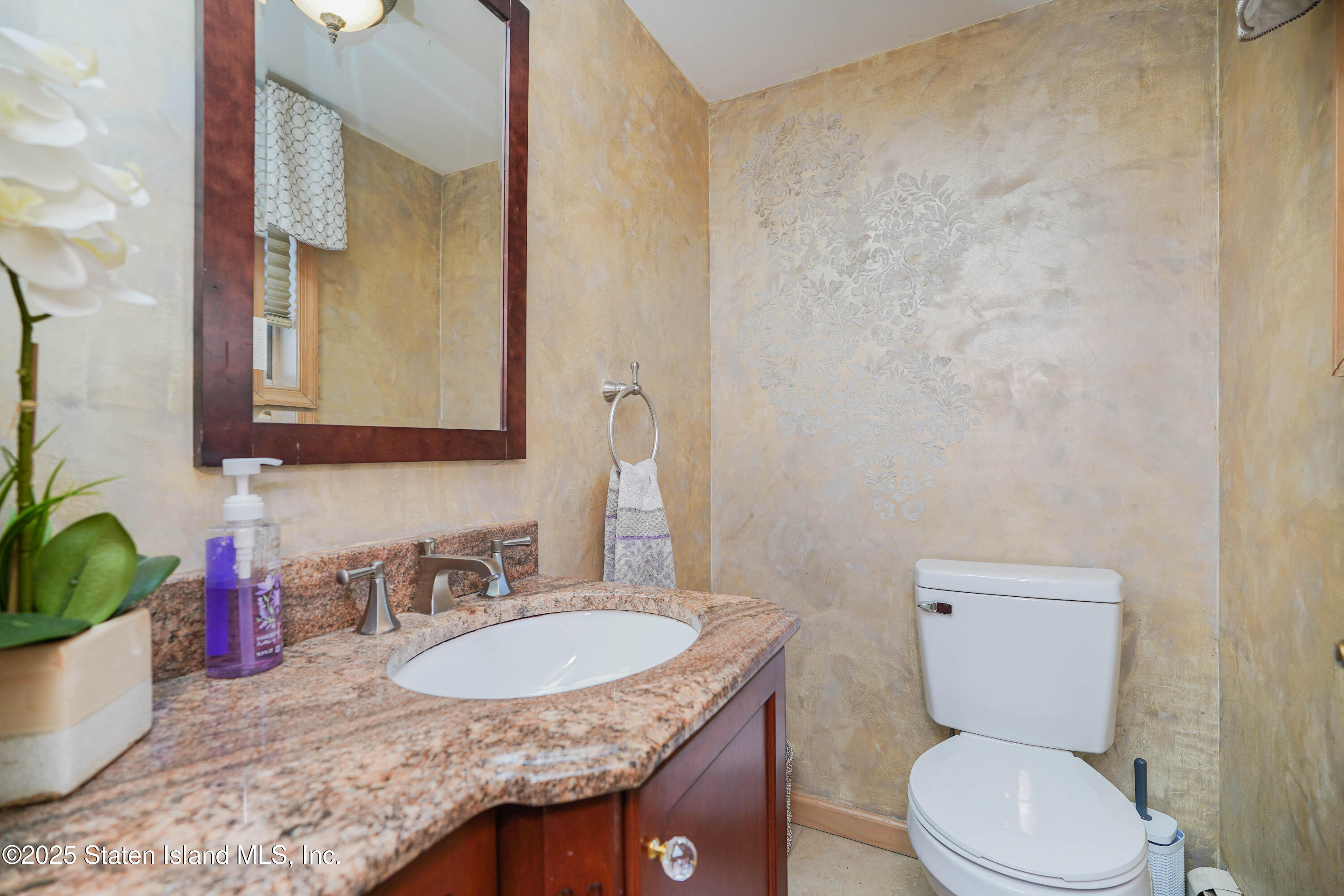 1527 Woodrow Road Staten Island, NY 10309 - Photo 33 of 37 a bathroom with a granite countertop sink a mirror and a toilet