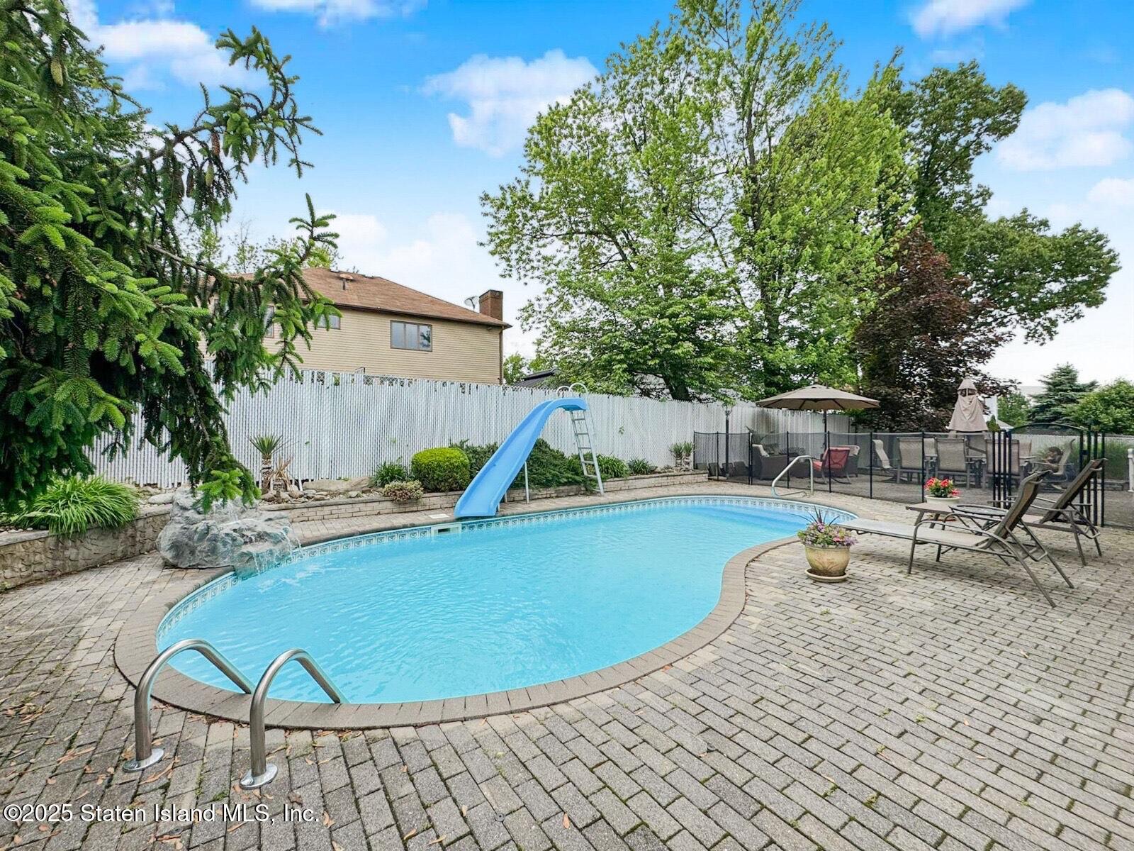 1527 Woodrow Road Staten Island, NY 10309 - Photo 35 of 37 a view of a swimming pool with sitting area