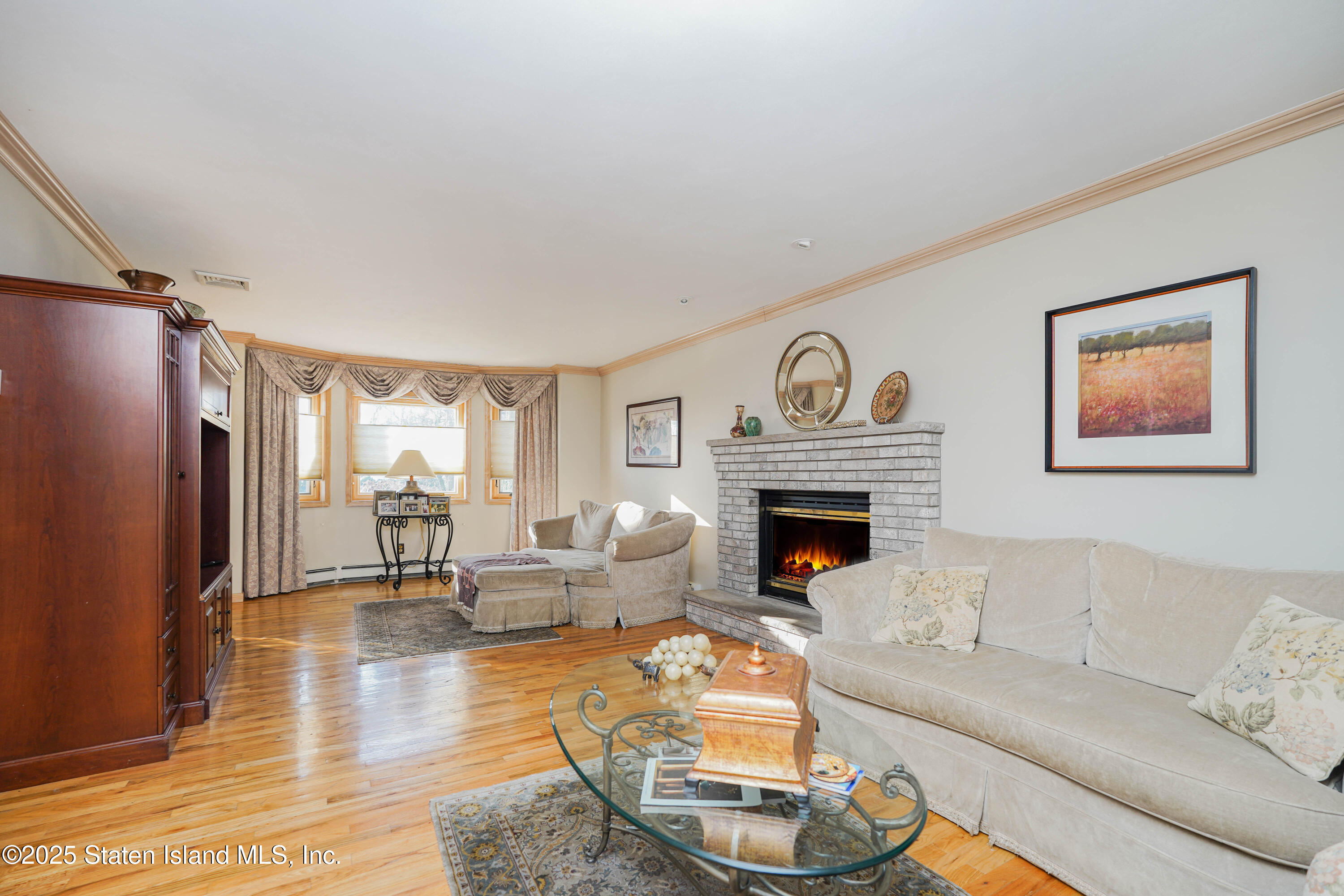 1527 Woodrow Road Staten Island, NY 10309 - Photo 5 of 37 a living room with furniture and a fireplace