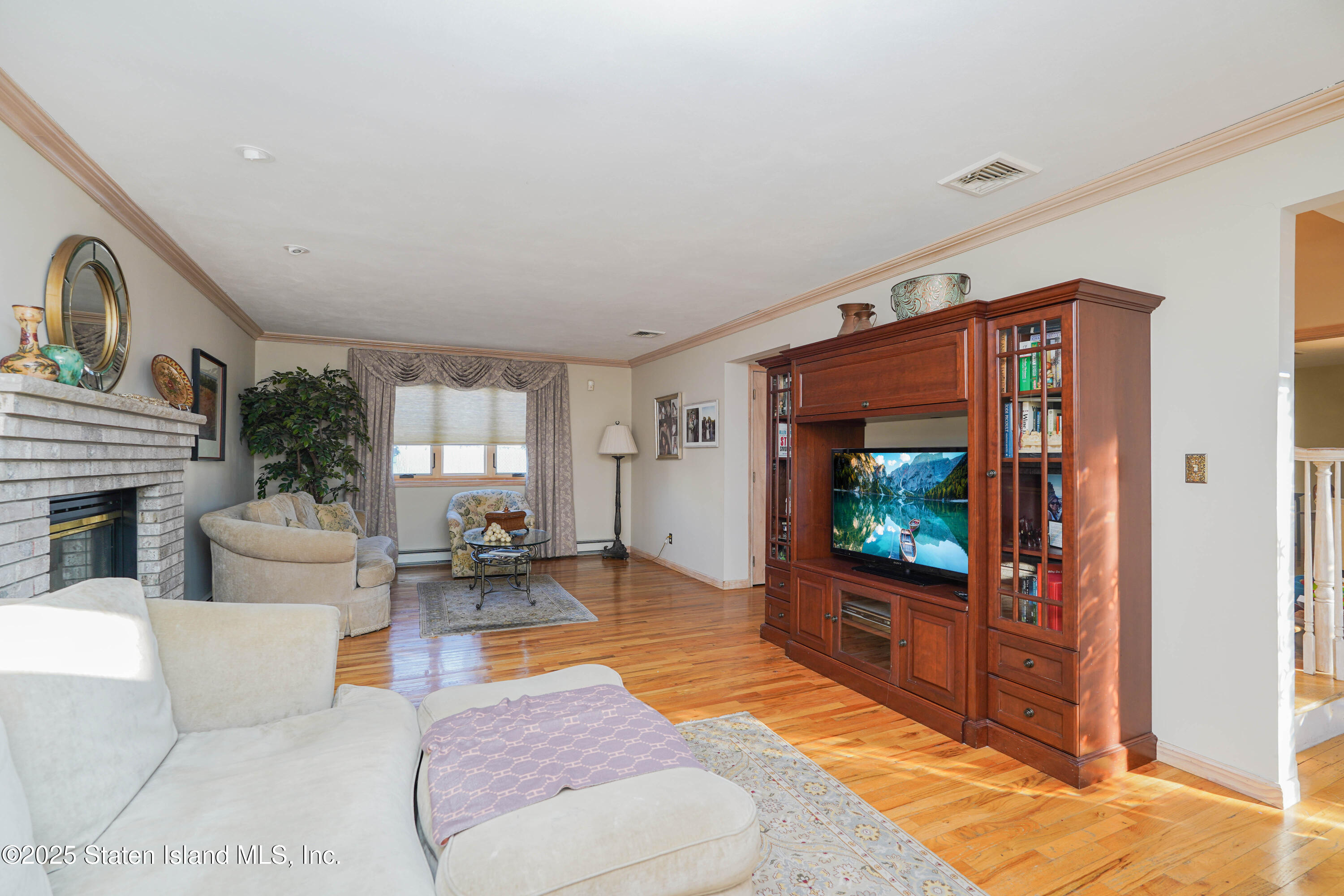 1527 Woodrow Road Staten Island, NY 10309 - Photo 6 of 37 a living room with furniture and a flat screen tv