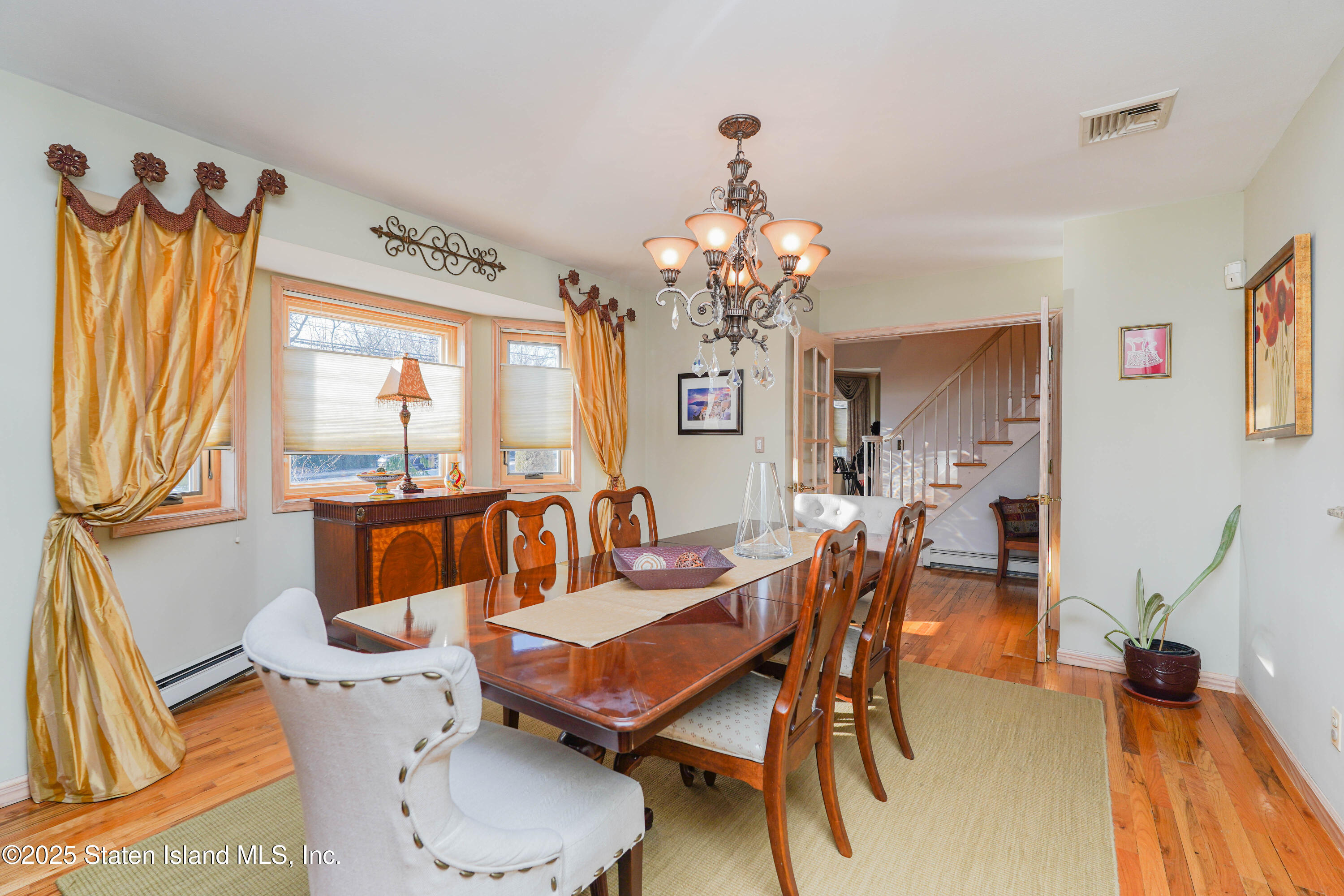 1527 Woodrow Road Staten Island, NY 10309 - Photo 9 of 37 a view of a dining room with furniture window and wooden floor