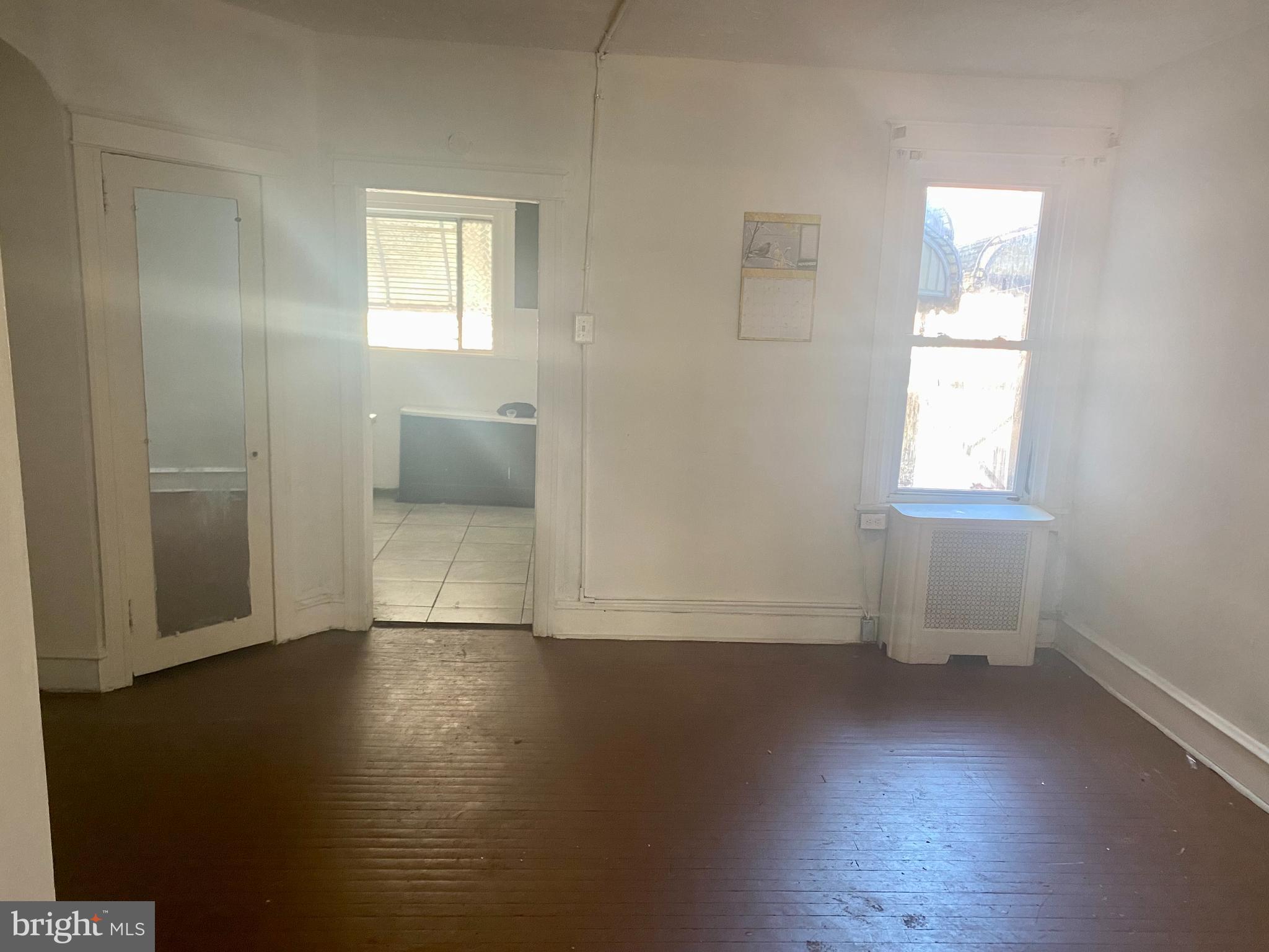 89 Lamport Road Upper Darby, PA 19082 - Photo 5 of 22 an empty room with wooden floor and windows