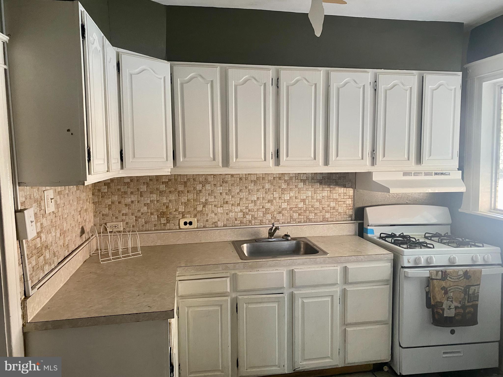 89 Lamport Road Upper Darby, PA 19082 - Photo 6 of 22 a kitchen with stainless steel appliances white cabinets and a stove