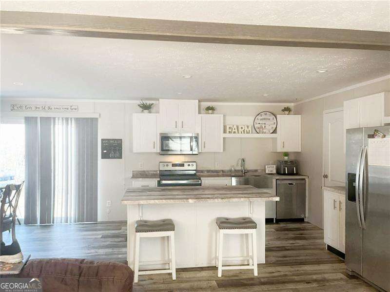 349 Dublin Circle Rome, GA 30161 - Photo 3 of 11 a kitchen with kitchen island stainless steel appliances a sink and cabinets