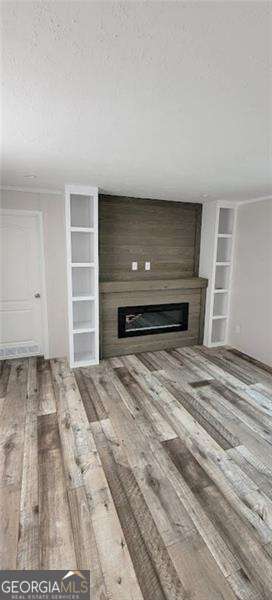 349 Dublin Circle Rome, GA 30161 - Photo 7 of 11 a view of empty room with a fireplace and wooden floor
