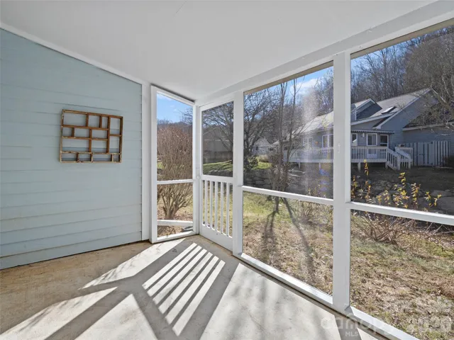 a view of a room with wooden floor and windows