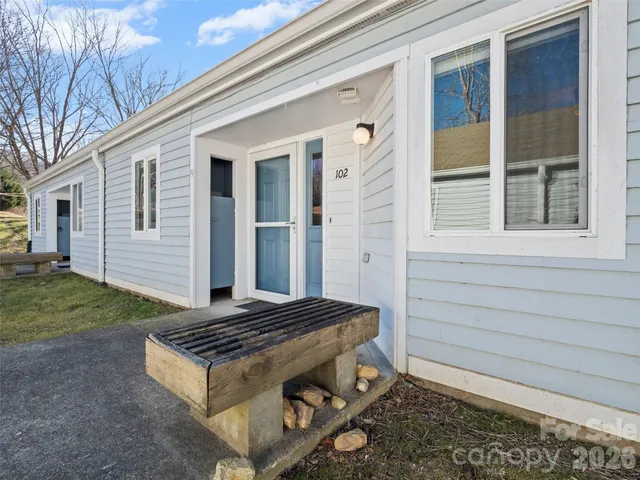 a view of backyard with a grill and a yard