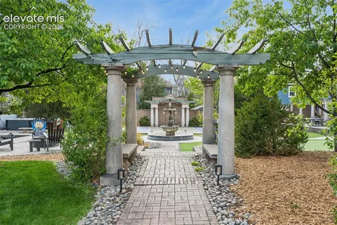 a front view of a building with a garden
