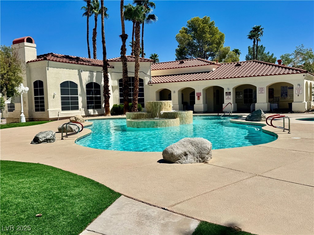Community pool featuring a patio area