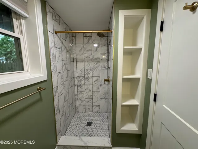 a bathroom with a shower and a sink
