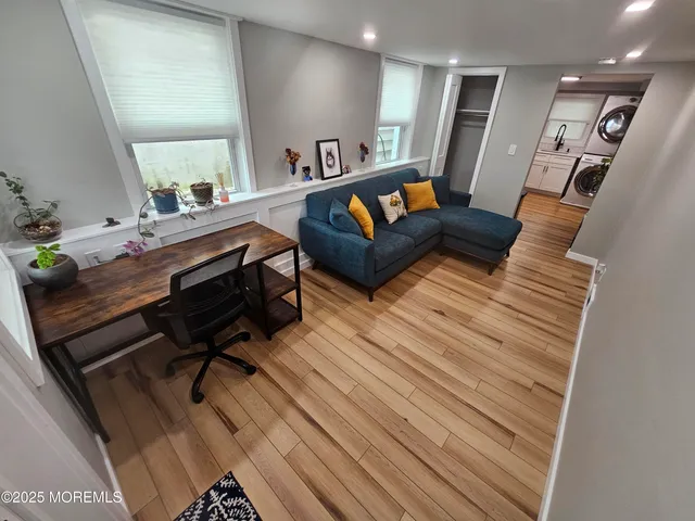 a living room with furniture and a wooden floor