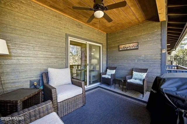 a outdoor living space with furniture and a ceiling fan