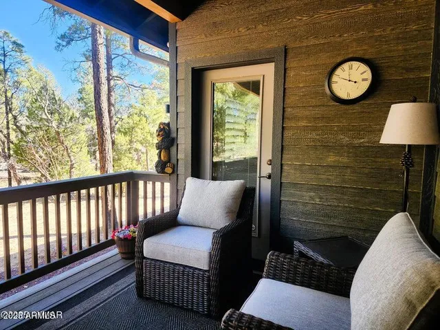 a view of a two chairs in the balcony
