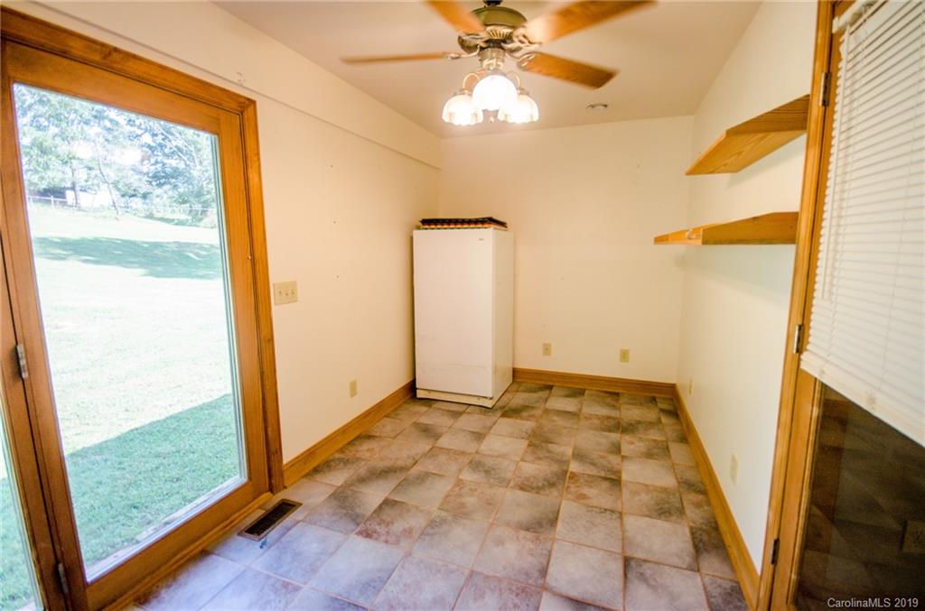 7061 Vashti Road Hiddenite, NC 28636 - Photo 22 of 47 wooden floor in an empty room with a window