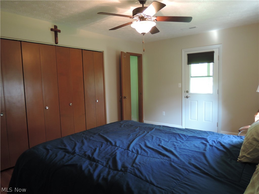 Master bedroom with a newer Anderson door to the balcony.