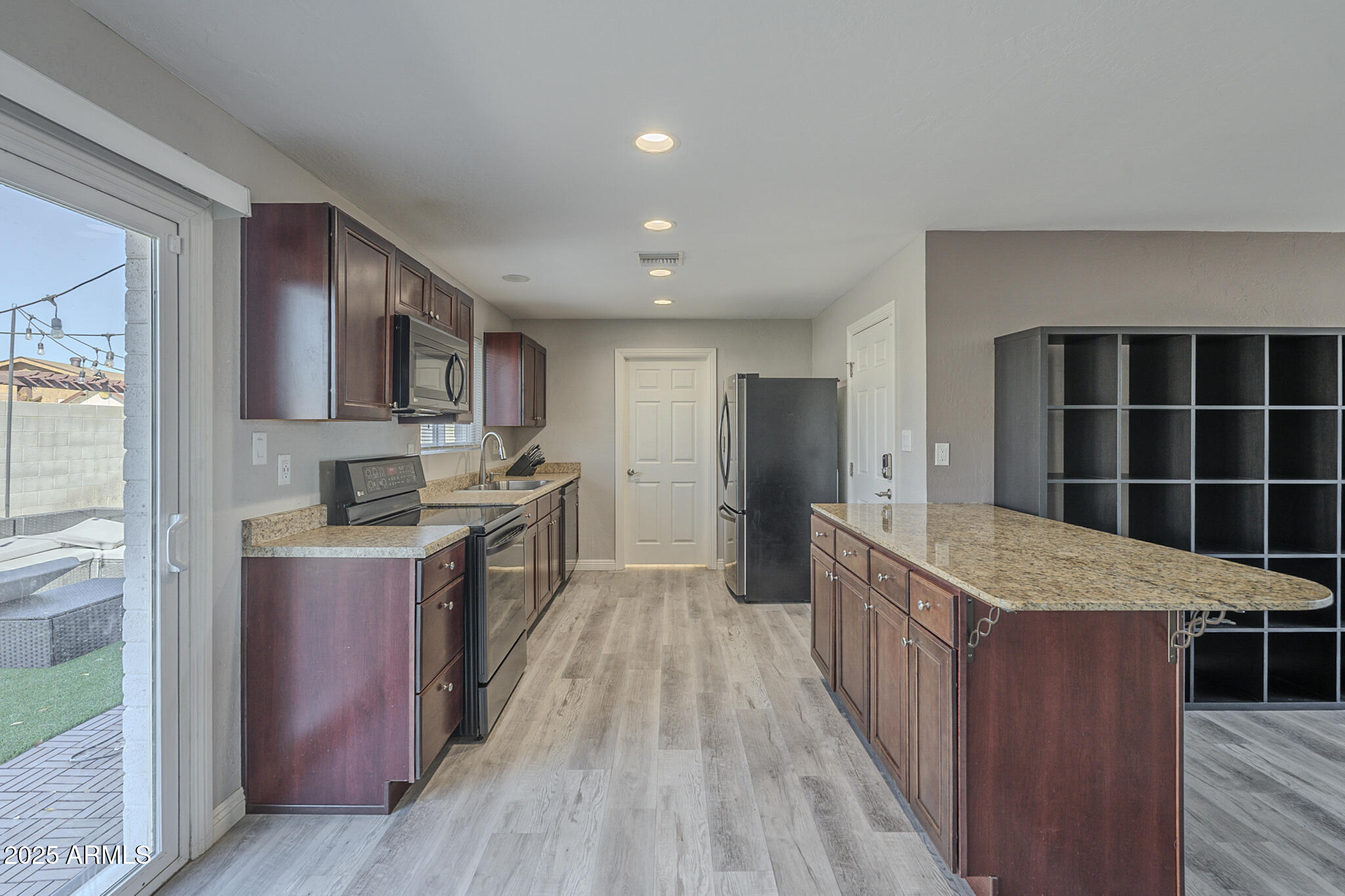 2914 East Cactus Road Phoenix, AZ 85032 - Photo 12 of 49 a kitchen with granite countertop a stove oven and a refrigerator