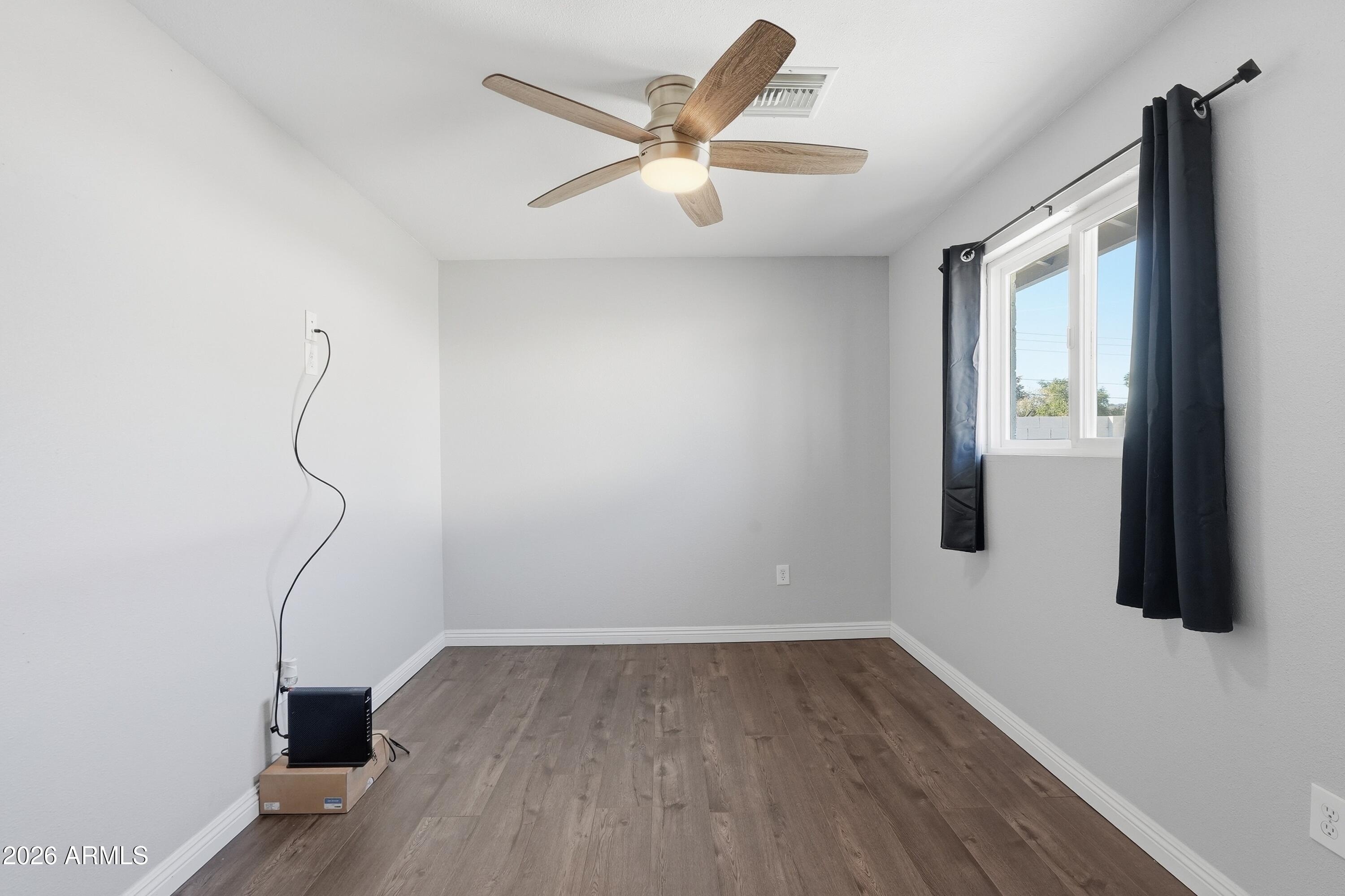 2914 East Cactus Road Phoenix, AZ 85032 - Photo 17 of 40 a room with window and ceiling fan