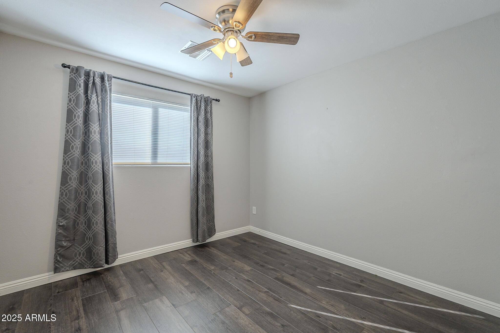 2914 East Cactus Road Phoenix, AZ 85032 - Photo 23 of 49 an empty room with a window and a fan