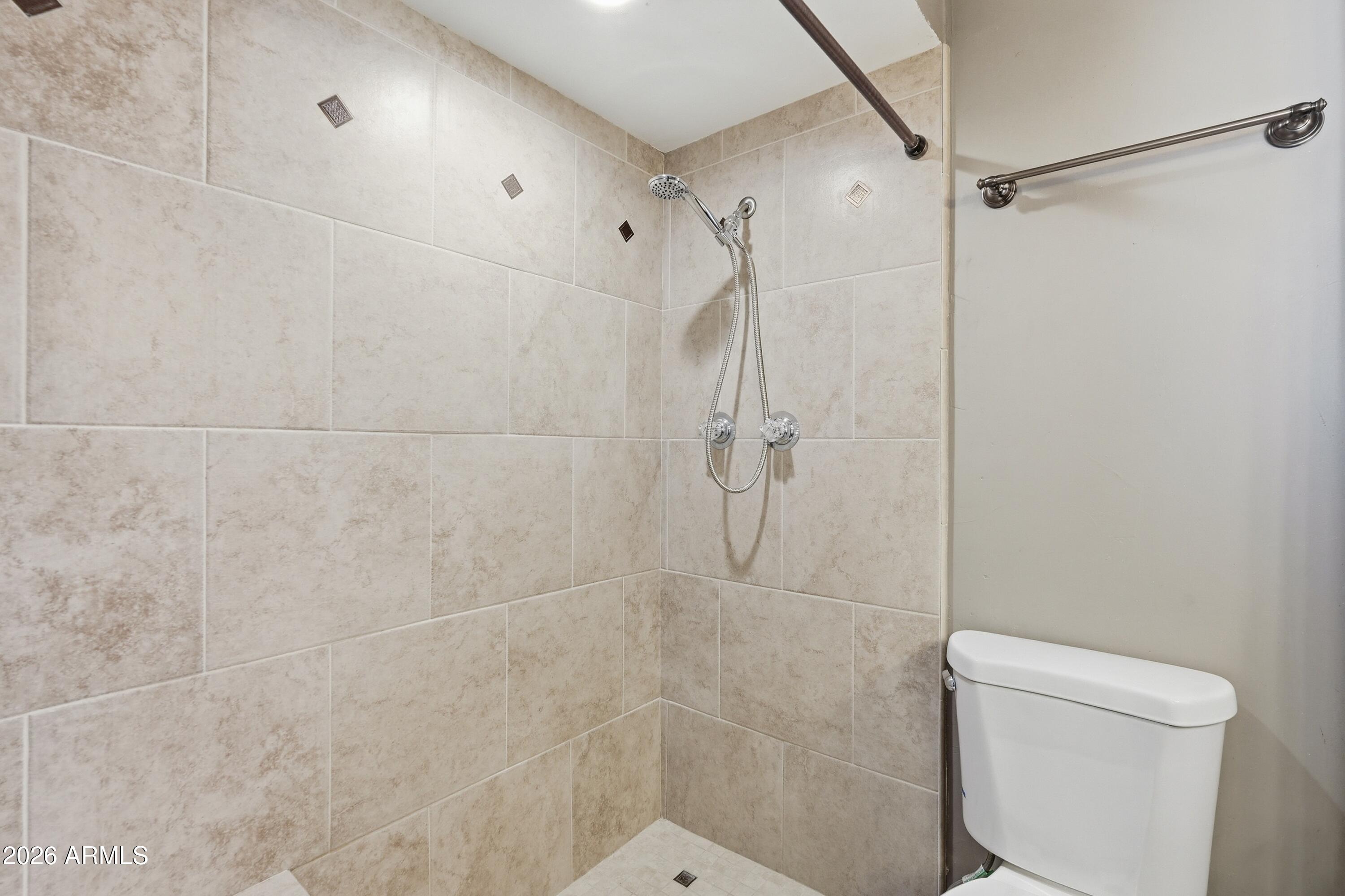 2914 East Cactus Road Phoenix, AZ 85032 - Photo 29 of 40 a bathroom with a shower and toilet