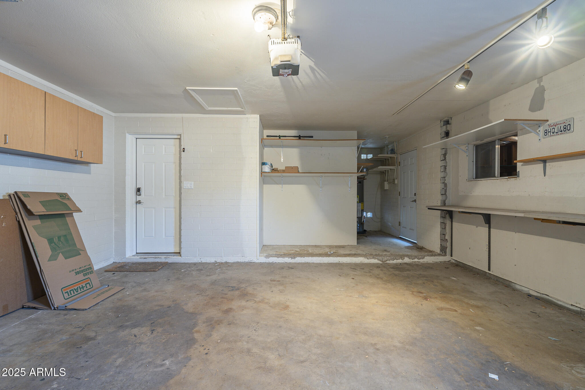 2914 East Cactus Road Phoenix, AZ 85032 - Photo 36 of 49 a view of a storage & utility room with refrigerator and mirror
