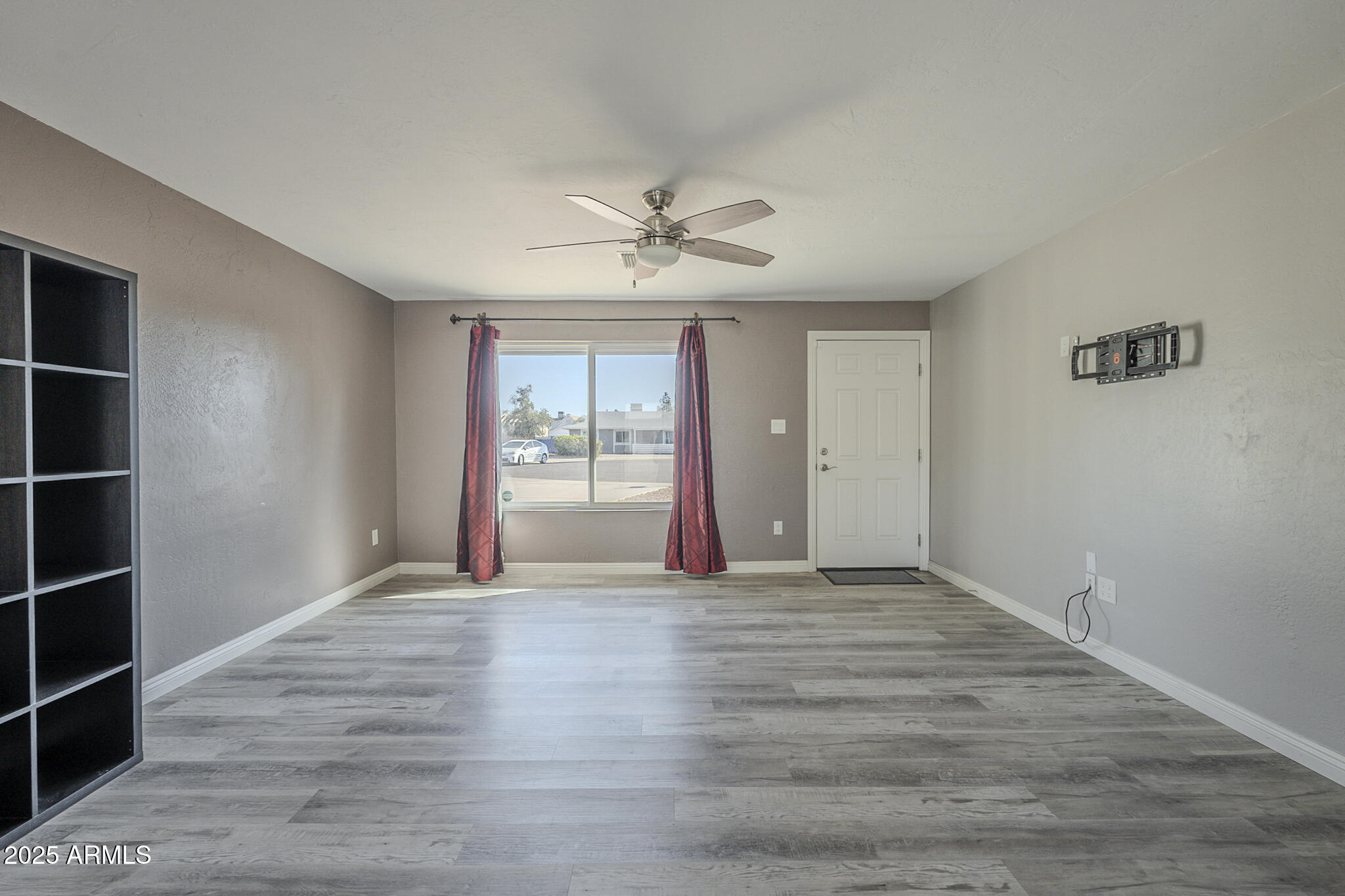 2914 East Cactus Road Phoenix, AZ 85032 - Photo 6 of 49 wooden floor in an empty room with a window