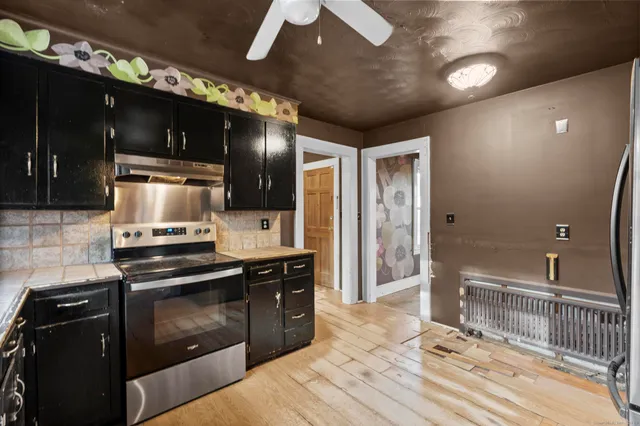 a kitchen with stainless steel appliances kitchen island granite countertop a refrigerator and a stove