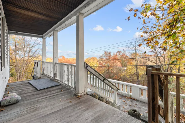 a view of a house with backyard and wooden fence