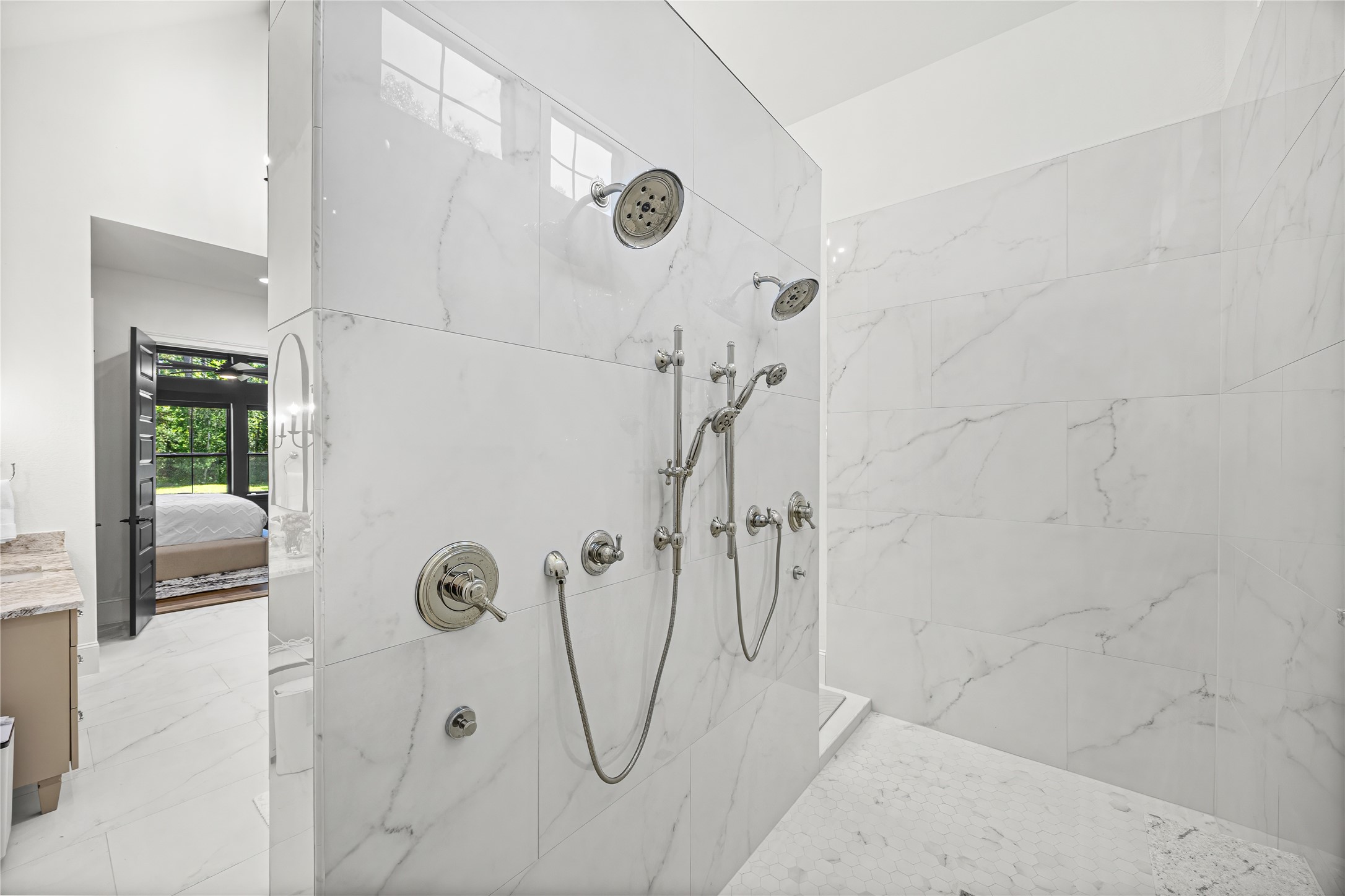 19314 Chateau Ridge Court Tomball, TX 77377 - Photo 17 of 50 A stunning marble walk-in shower equipped with dual rain heads, body sprays, and handheld fixtures, creating a resort-level retreat at home