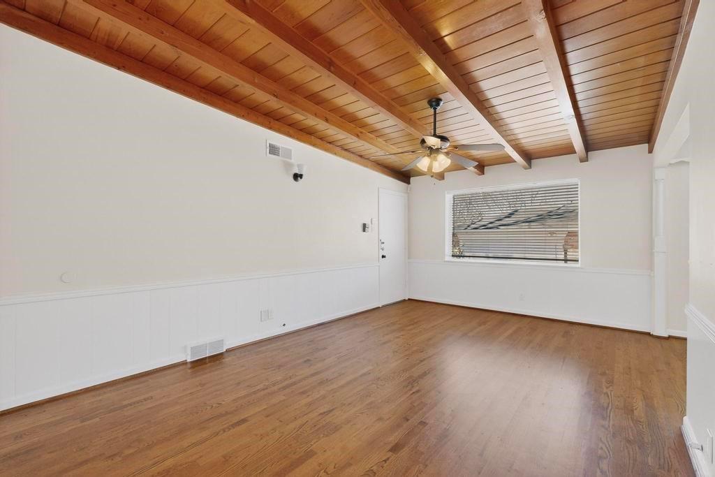 2120 Healey Drive Dallas, TX 75228 - Photo 20 of 39 an empty room with wooden floor and windows