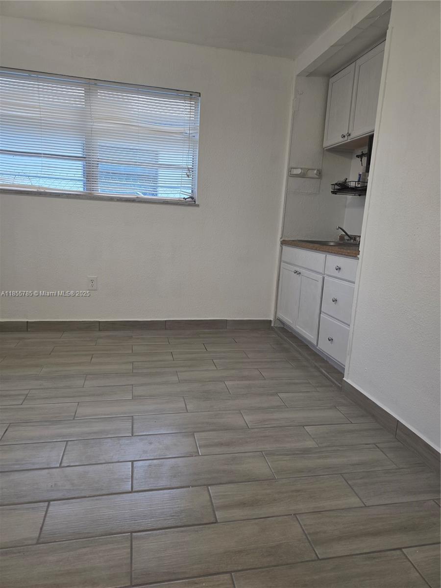 359 West 12th Street, Unit 2 Hialeah, FL 33010 - Photo 11 of 20 a kitchen with white cabinets and white appliances