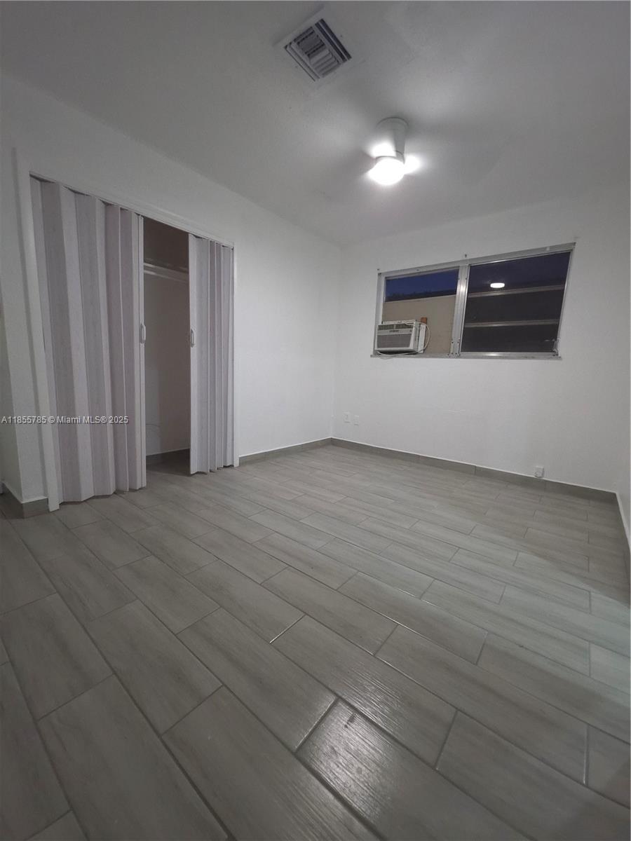 359 West 12th Street, Unit 2 Hialeah, FL 33010 - Photo 15 of 20 a view of wooden floor and windows in a room
