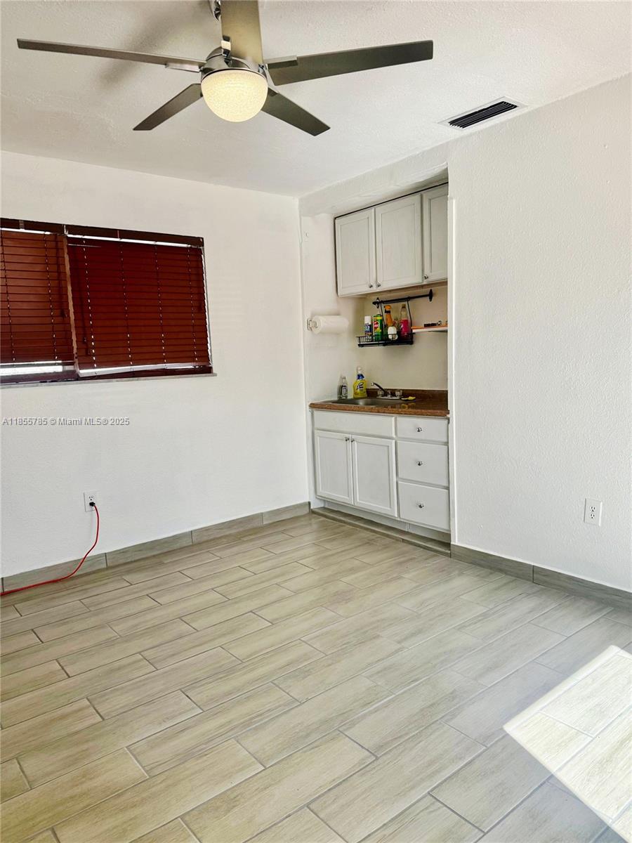 359 West 12th Street, Unit 2 Hialeah, FL 33010 - Photo 2 of 20 a kitchen with granite countertop white cabinets and white appliances